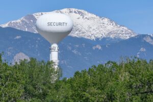 Security Water tower in front of a snow-covered mountain landscape