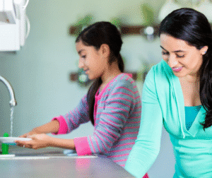Mom and daughter wash dishes and fill dishwasher